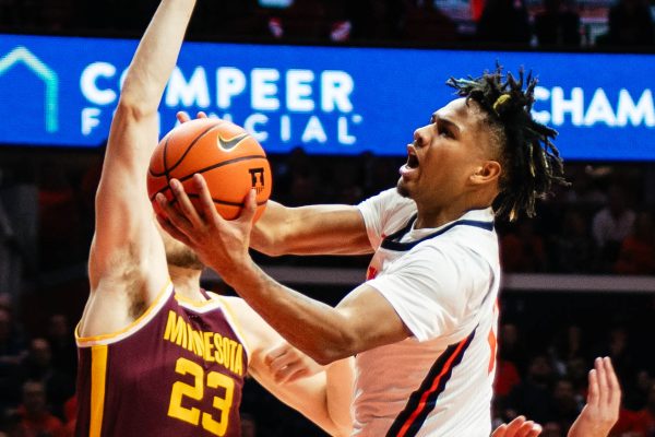 Fifth year guard Terrence Shannon Jr. leaps in the air to attempt a layup against Minnesota on Wednesday. The Illini defeated the Golden Gophers by eight points at the State Farm Center.