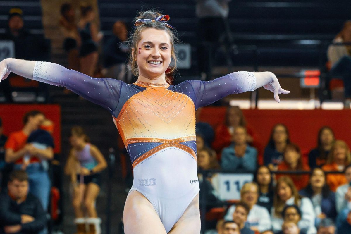 All-around senior Kaitlyn Ewald poses as she performs on the balance beam at Huff Hall on Sunday.
