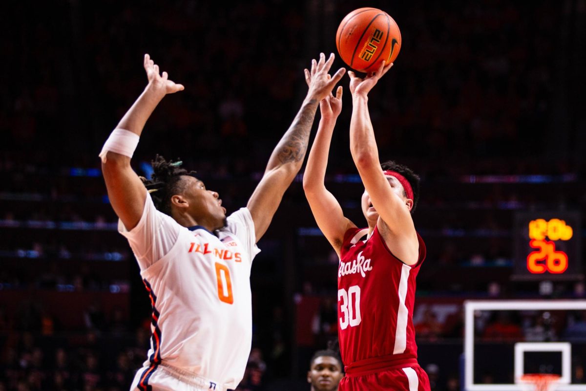 Guard Terrence Shannon Jr. jumps in a attempt to block a shot from Nebraska senior guard Keisei Tominaga during the second half of Sunday evenings game. 
After going into overtime the Illini defeated the Cornhuskers by 87-84.