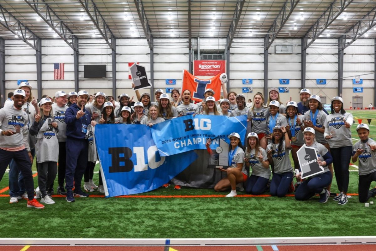 Illini womens track team together as they celebrate their BIG Ten victory over the weekend.
