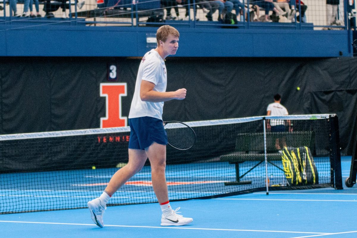 Junior Karlis Ozolins pumps his fist after winning a point against Duke in the match on Feb. 2.