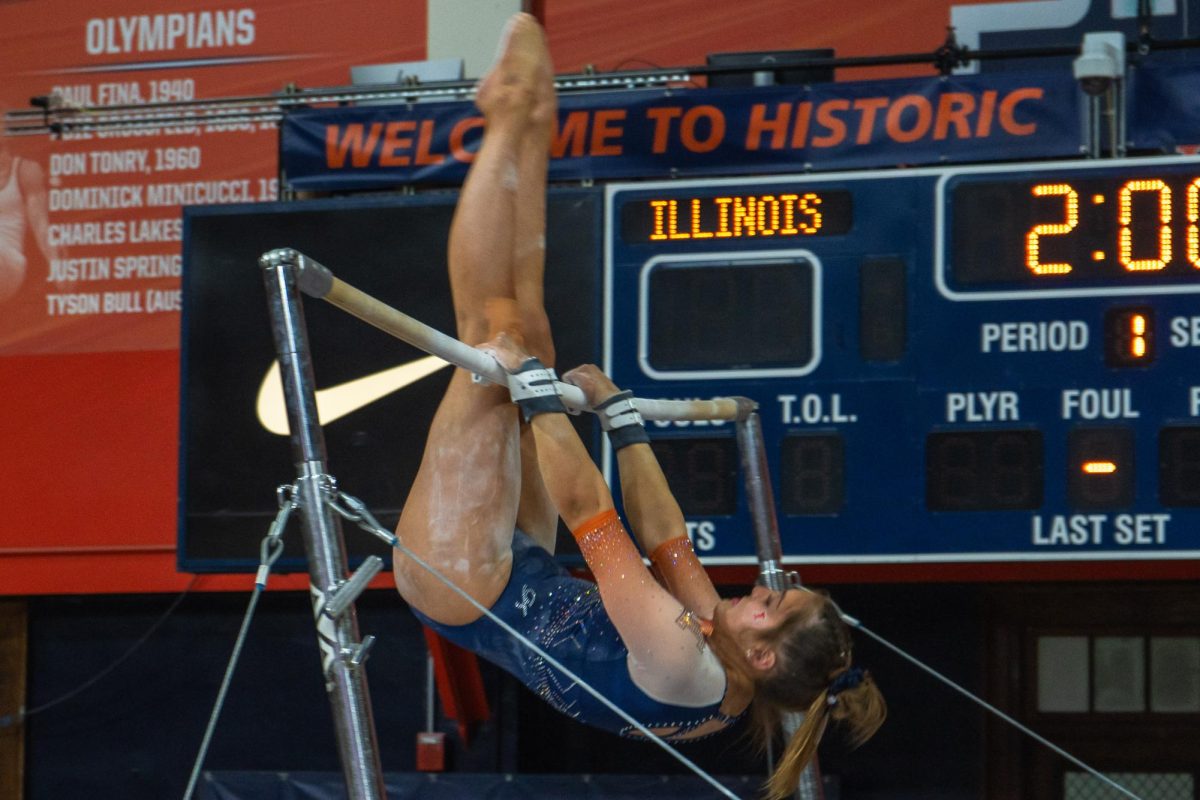 An+Illini+gymnast+prepares+for+a+big+swing+on+the+uneven+barrs+during+the+meet+with+Minnesota+at+Huff+Hall+on+Feb.+18.+