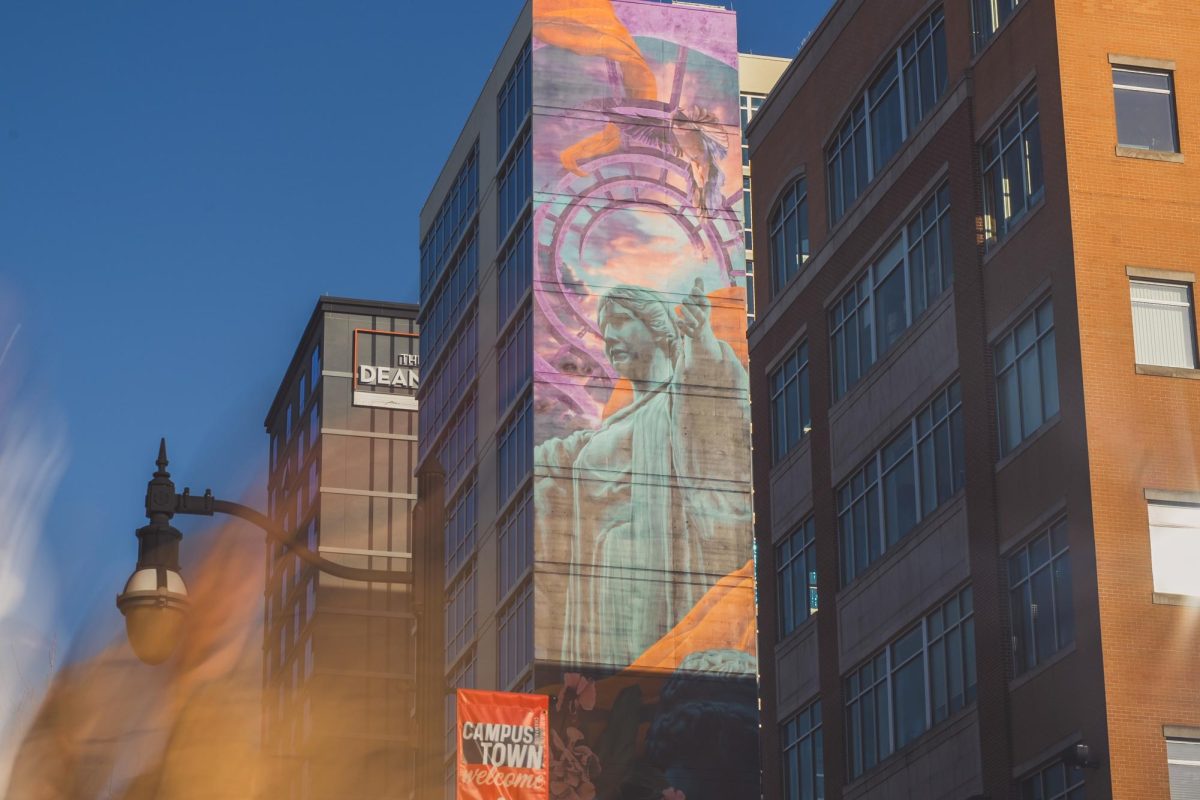 The mural of Alma Mater on Skyline Tower peeks out from adjacent buildings, as seen towering over Green Street on Feb. 25.