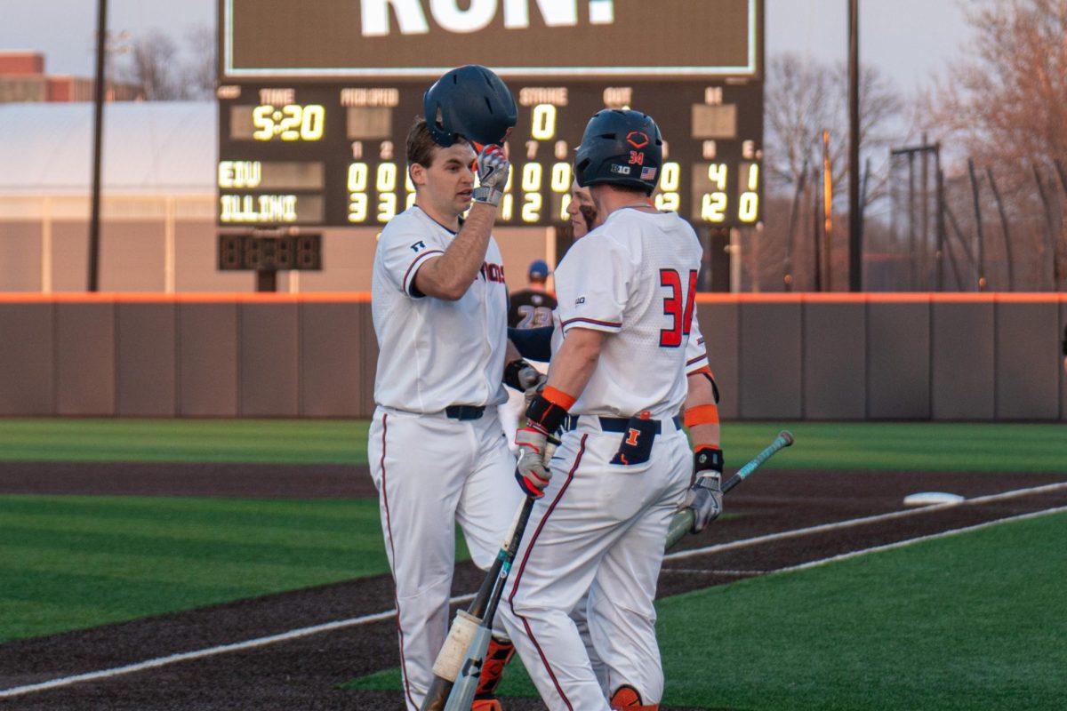 Graduate+student+Jacob+Schroeder+scores+his+second+home+run+and+celebrates+with+redshirt+junior+Drake+Westcott+on+Feb.+28.