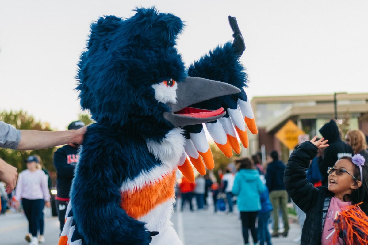 The Kingfisher mascot gives out a high five during the 2023 Homecoming Parade on Oct. 20.
