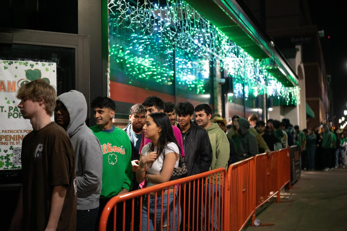 Students from the Champaign-Urbana community celebrate the 2024 Unofficial St. Patricks Day at KAMS, which was decorated like an Irish pub, on March 2.