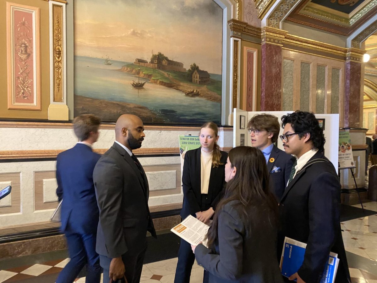 (Starting second from left) Michelle Weber, senior in LAS; Jocylin Sada, senior in LAS; Rudy LaFave, junior in ACES; Raphael Ranola, sophomore in LAS talking to Rep. Kevin Ollickal (left) about House Bill 5268 on March 13.