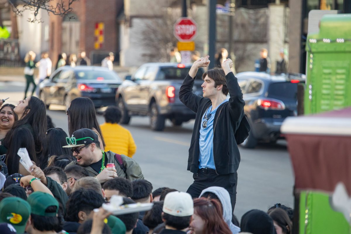 Sophomore in LAS Michael Decoste jubilates in front of a house party on Green and Third St. on Saturday.