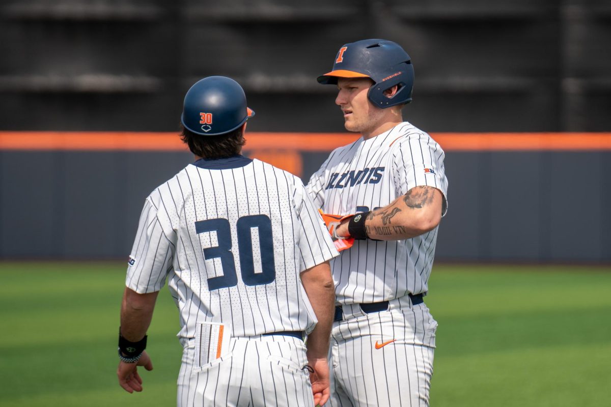 Junior infielder Vytas Valincius and assistant coach Curt Courtwright chat after Vytas run to first base.