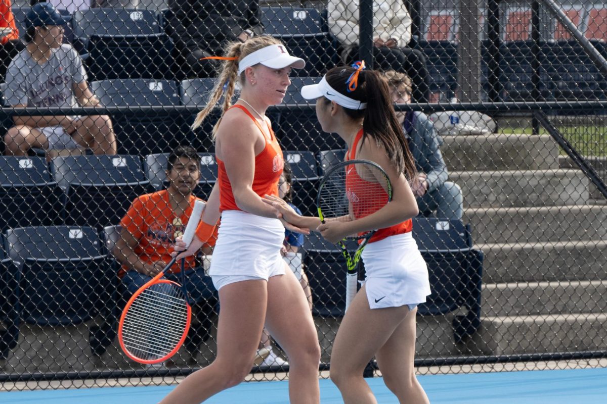 Doubles team Megan Heuser and Alice Xu celebrate winning a point against Northwestern on March 30.
