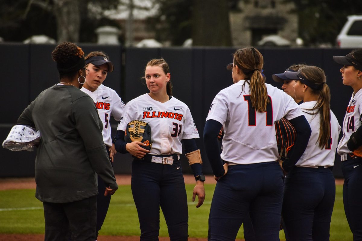 The Illini chat during a timeout after a rocky start to the inning on April 10.
