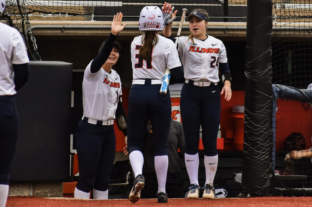 The+Illinois+softball+team+celebrates+in+the+dugout+after+junior+infielder+Megan+Ward+scored+during+the+Illinois+v+Southern+Illinois+game+on+April+10.