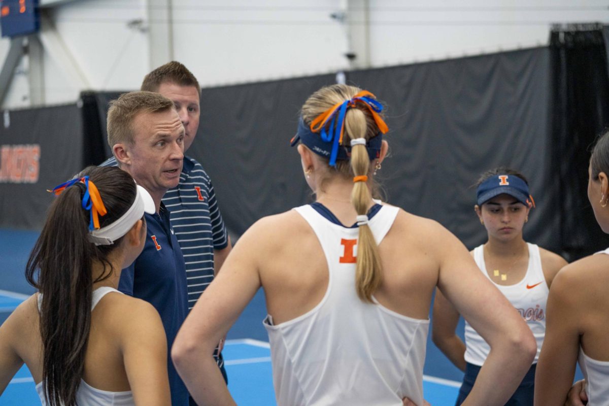 Head coach Evan Clark talks to the Illinois women’s tennis team before the Illinois v. Indiana match on Friday, April 12 in the Atkins Tennis Center on South Goodwin Avenue.