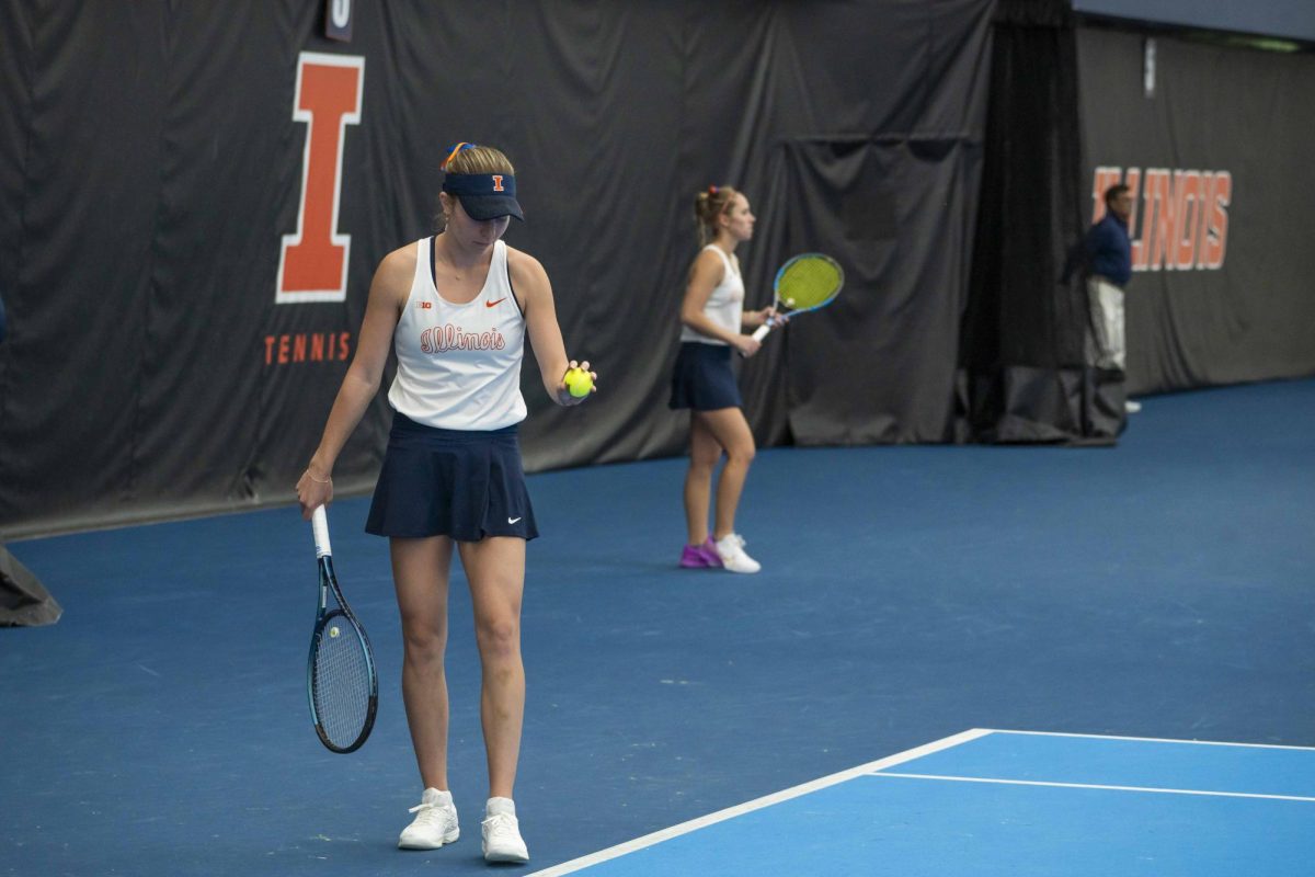 Fifth year Josie Frazier prepares to serve during her first double match of the Illinois v. Indiana match on Friday, April 12 in the Atkins Tennis Center on South Goodwin Avenue.