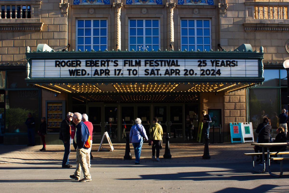 People converse outside the entrance to Virginia Theater on West Park Avenue for Ebertfest on April 17

