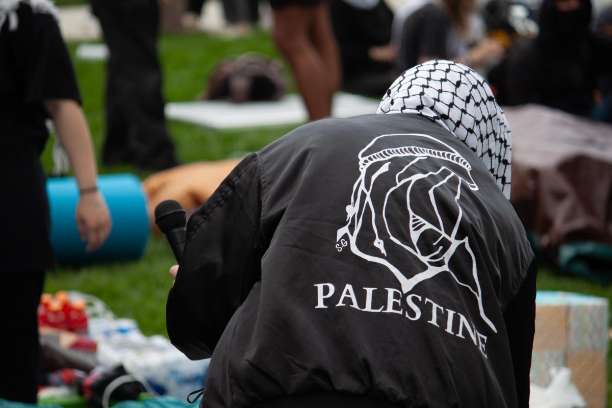 Protesters wear Keffiyeh and Palestine jackets as they lay out resources.