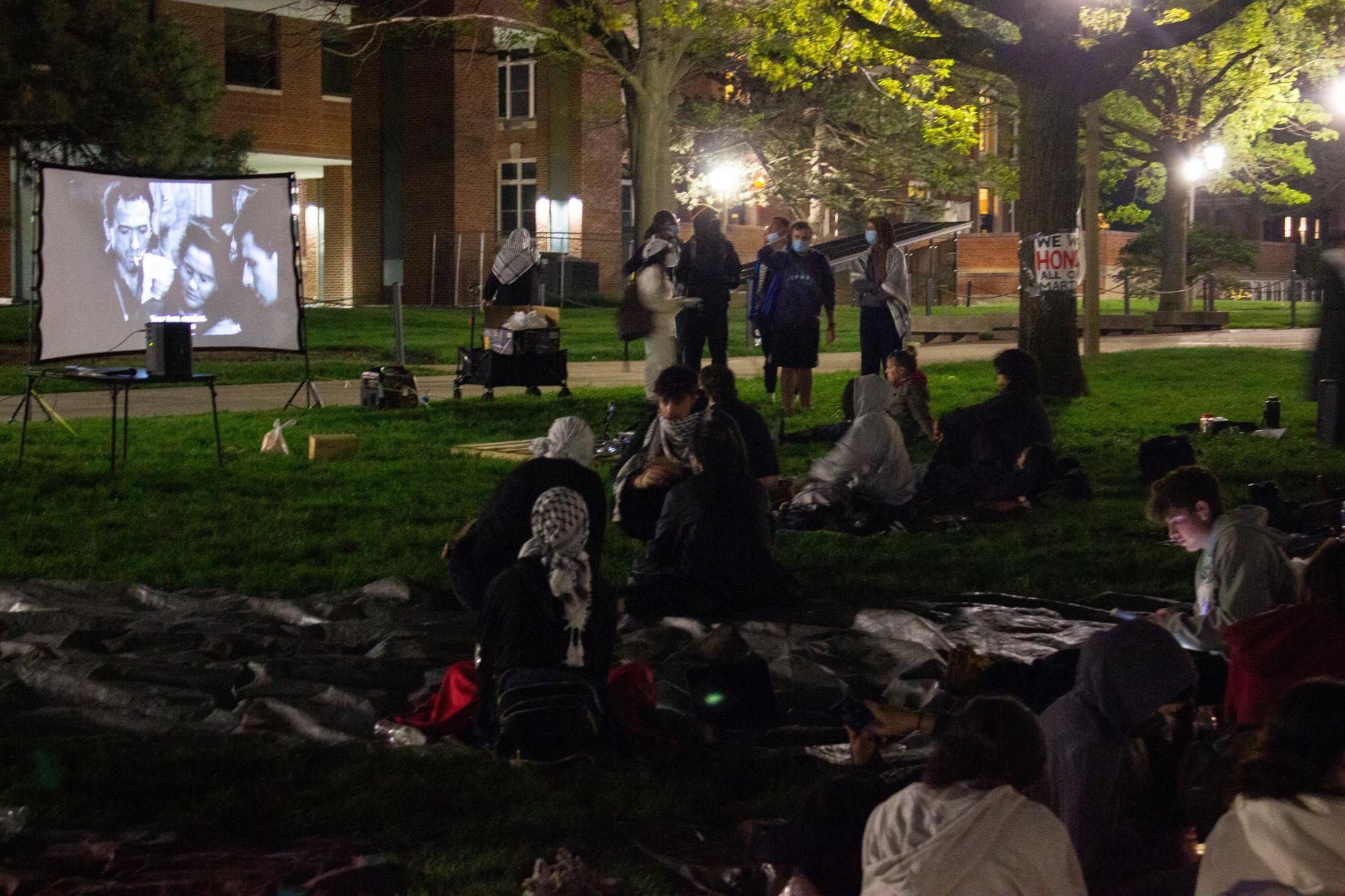 People gather at the Main Quad in the evening to view a screening held at the Palestine encampment protest on Monday night.