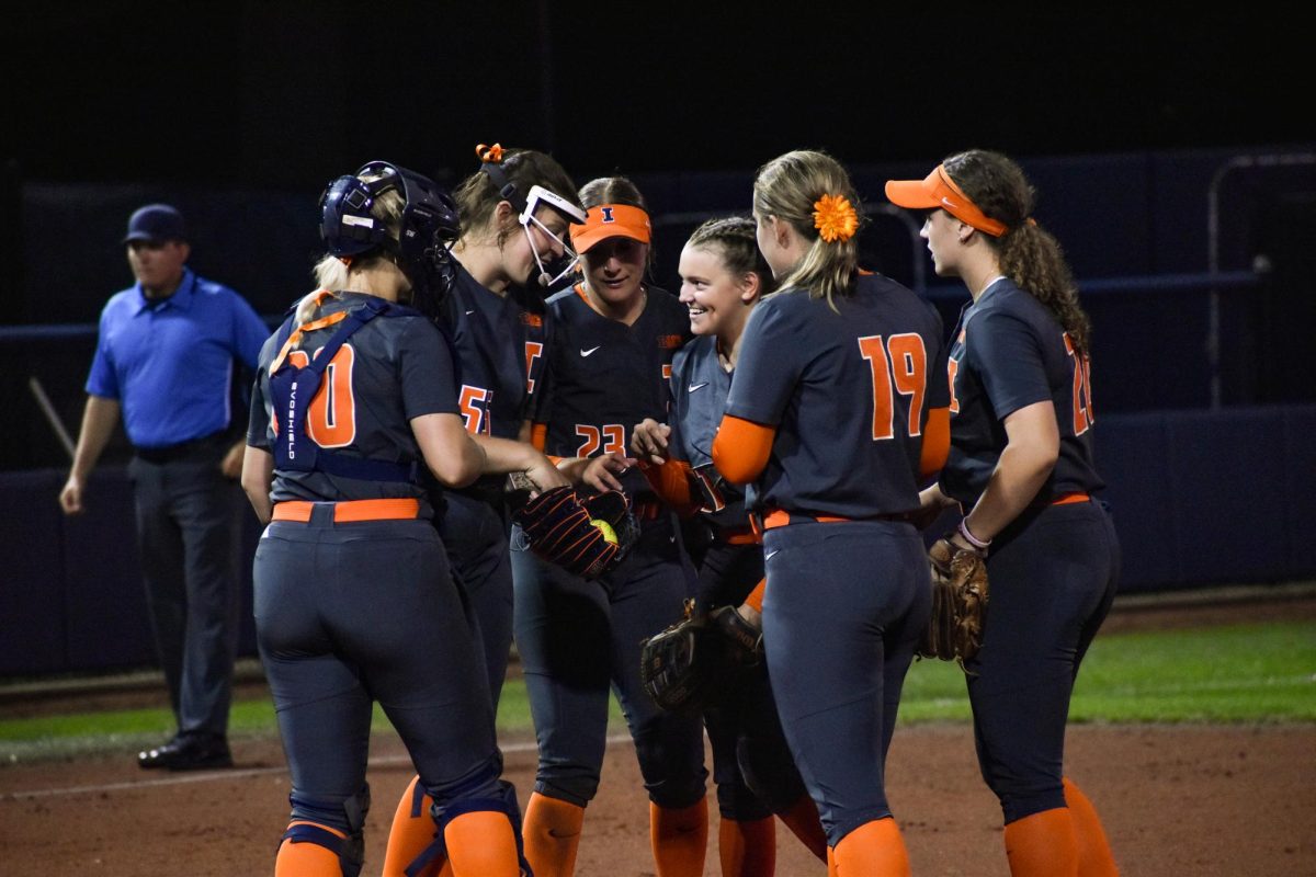 The+Illini+talk+before+a+defensive+inning+during+a+game+against+Parkland+College+on+Sept.+28.%0A