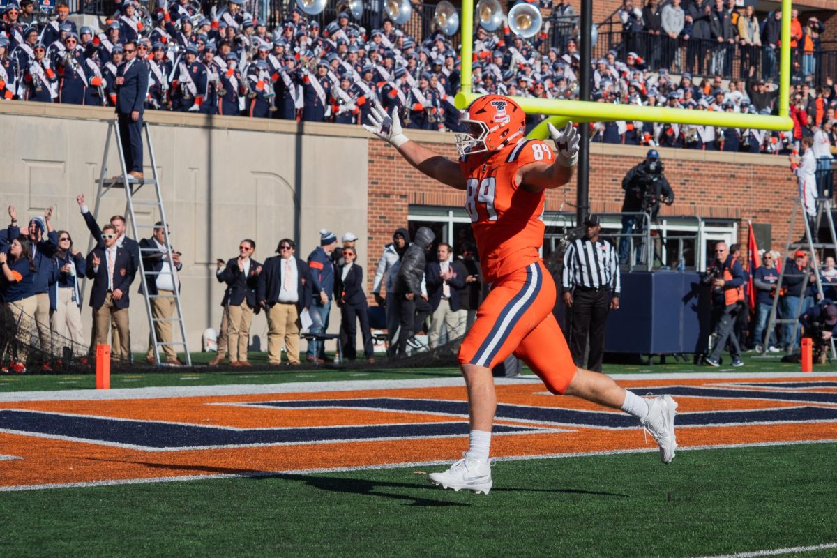 Tight end Tip Reiman races to the end zone to celebrate a touchdown against Indiana on Nov. 11 2023.