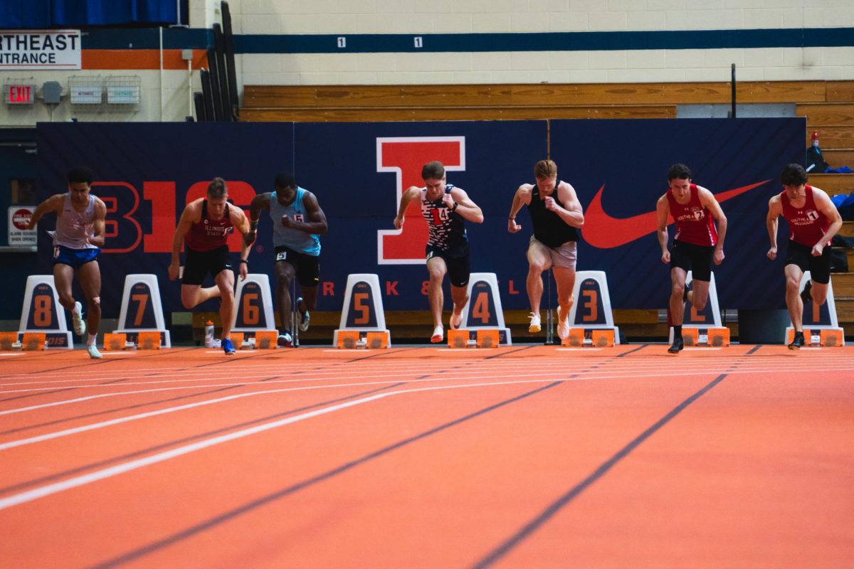 Illinois Track and Field Assistant Head Coach Ken Mullings competing unattached and senior Aiden Ouimet take first and second respectively during the 60-meter dash on Jan. 26.