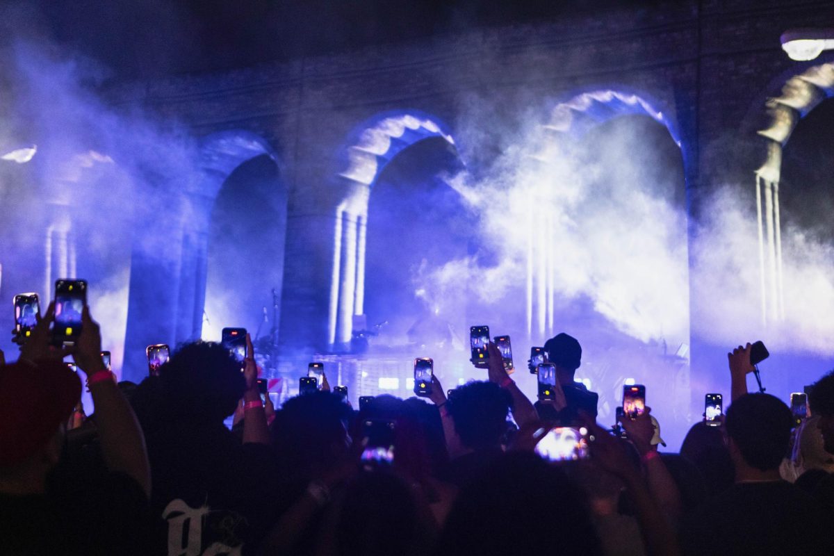 Concert attendees pull out their phones as a Boogie Wit Da Hoodie’s set begins at the State Fam Center on Sept. 9. NLE Choppa’s Spring Jam set will be moved to the State Farm Center.