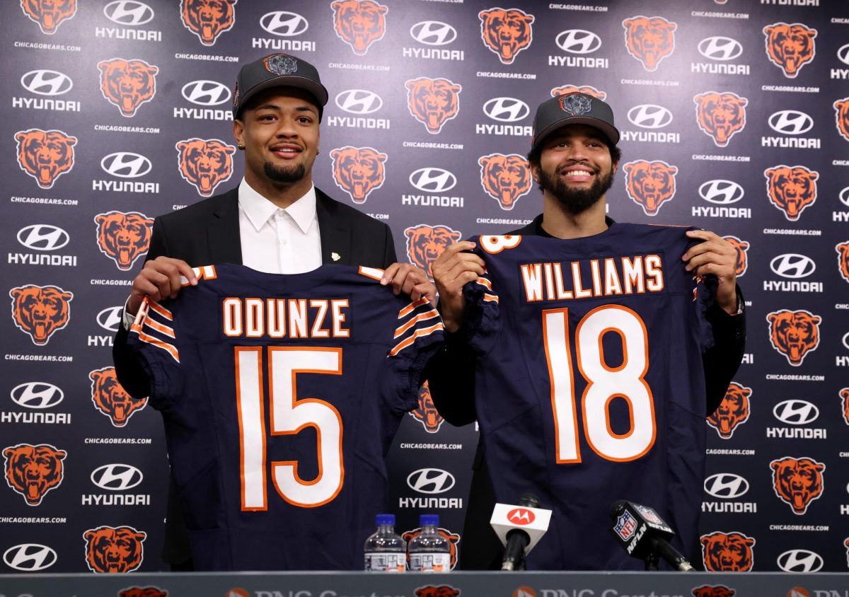 New Bears wide receiver Rome Odunze and quarterback Caleb Williams pose for photographs at Halas Hall on April 26.