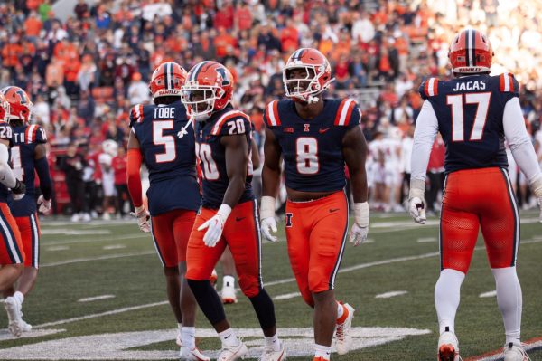Defensive players Tarique Barnes, Tyler Strain and Zachary Tobe leave the field after a turnover during the Homecoming Football game against Wisconsin on Oct. 21.
