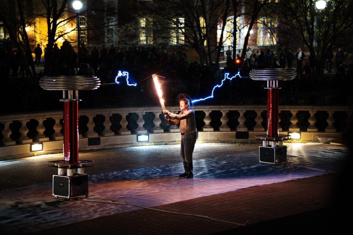 A professor demos the Tesla coil at the end of the day by setting a piece of wood on fire.