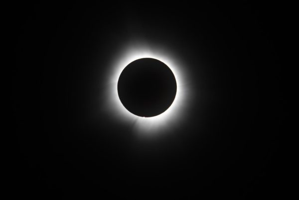 The corona of the solar eclipse radiates light during full totality. On Monday,  students flooded campus, ditched classes and took a trip to experience this once-in-a-lifetime event in Illinois.