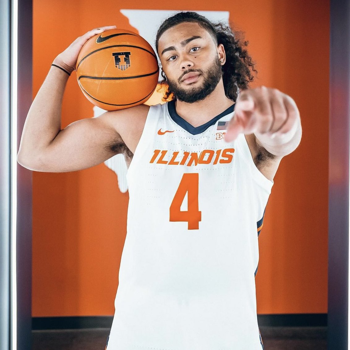 Champaign native Kylan Boswell poses with a basketball for promotional photos with Illini Athletics.