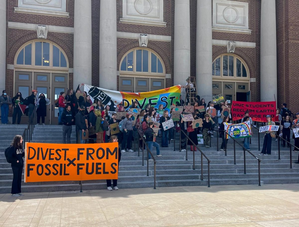 Protestors+gather+outside+Foellinger+Auditorium+to+advocate+against+fossil+fuel+investment+on+April+22.