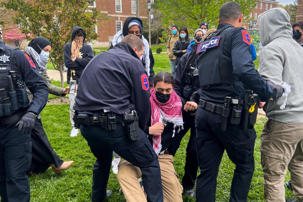 University police take a hold of protestor as they proceed to put them under arrest.