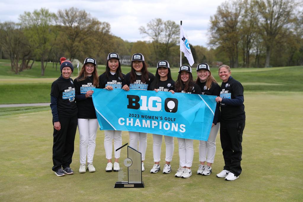 The 2023 Illini Womens Golf Team hoists the banner and trophy after winning the Big 10 Championship last year.