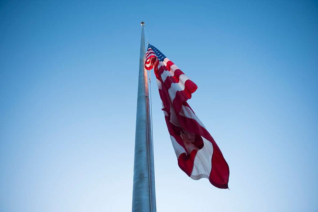 An American flag flies at half-mast.