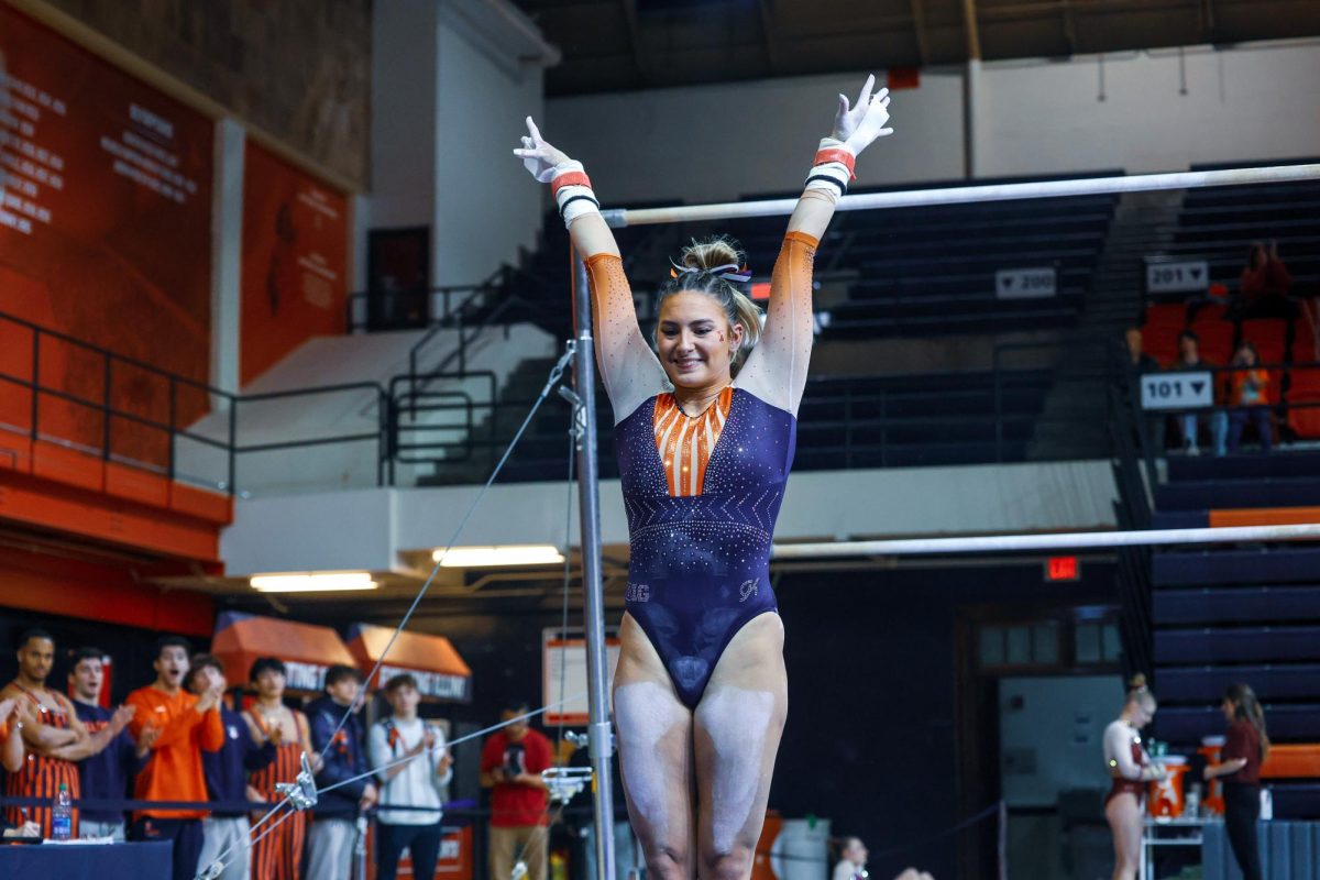 Rising+fifth-year+Amelia+Knight+strikes+a+pose+as+she+dismounts+the+uneven+bars+during+a+gymnastics+meet+against+Minnesota+on+Feb.+18.