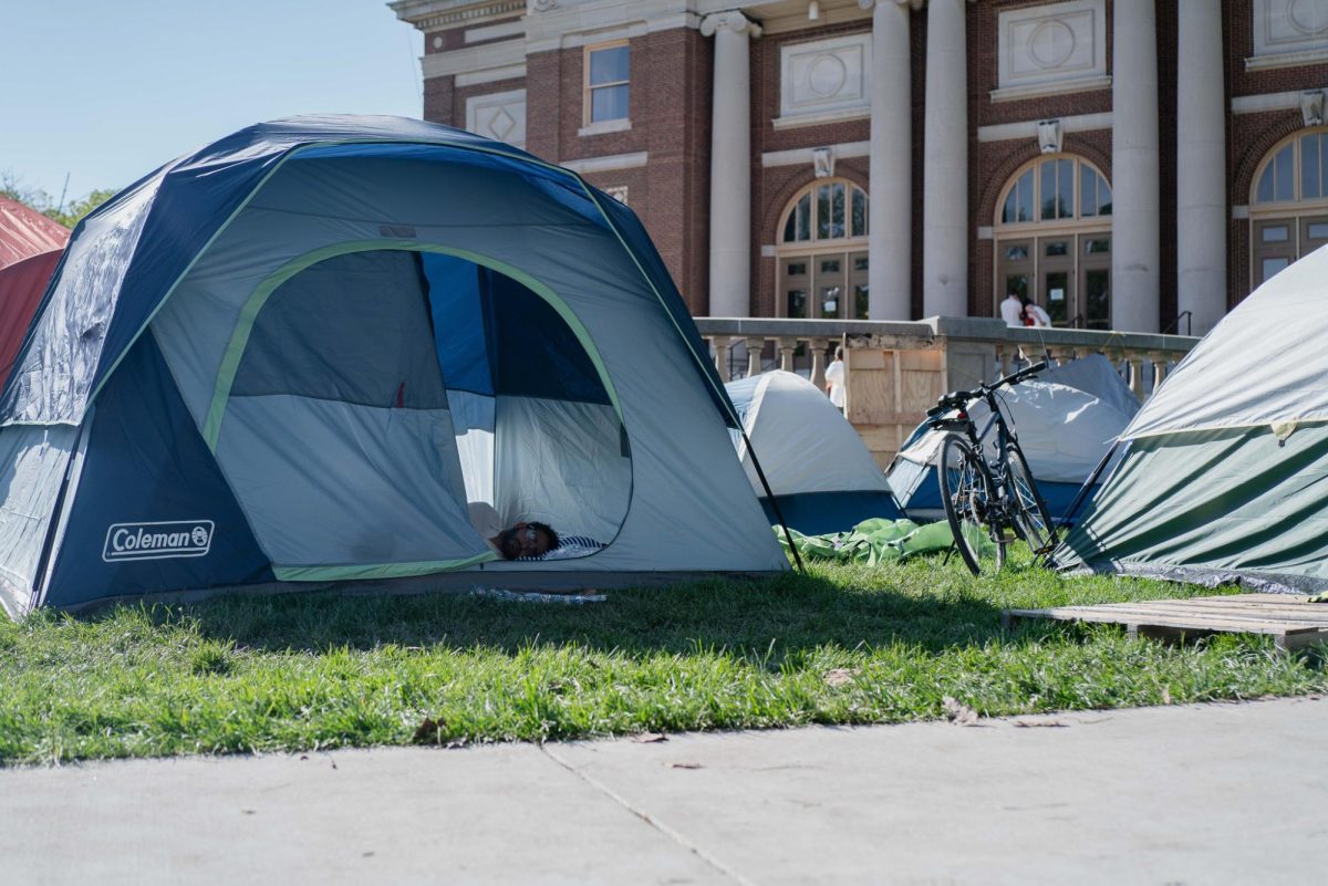 Protesters rest in tents stationed in front of Foellinger Auditorium early Thursday morning.