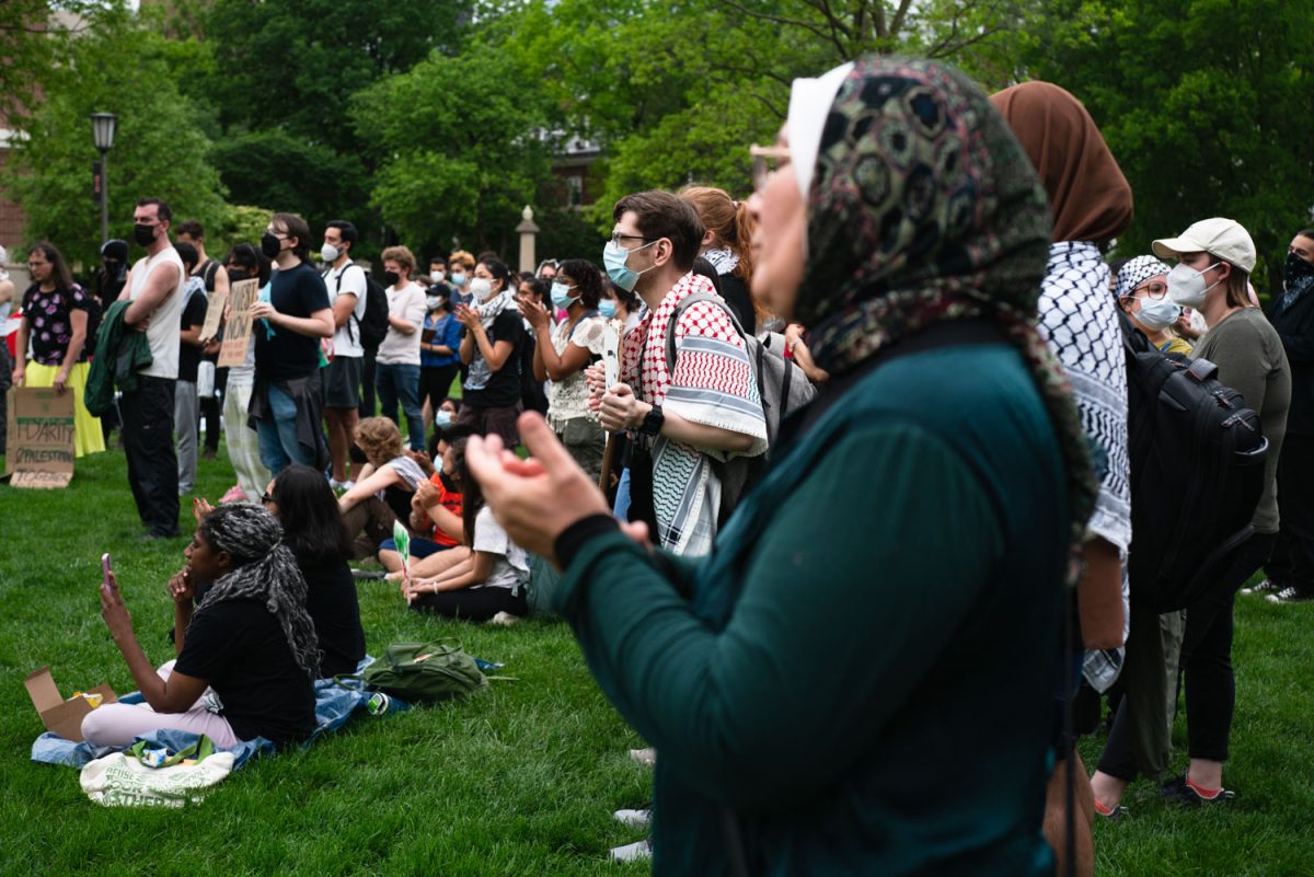 Protestors applaud during a rally held in front of Foellinger Auditorium on the Main Quad during Monday afternoon.