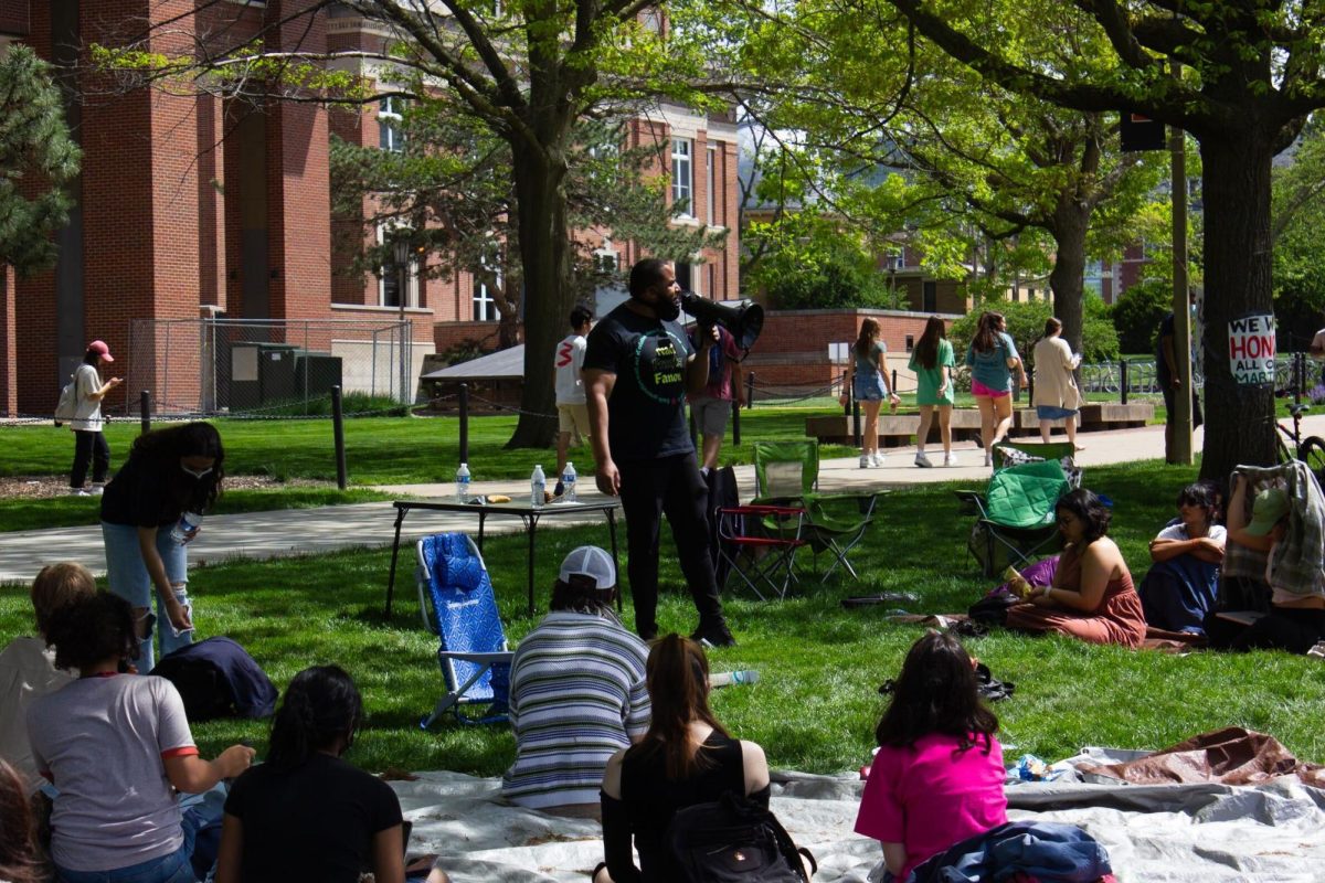 Assistant Professor Augustus Wood from the School of Labor & Employment Relations speaks to students in the encampment on the morning of Wed. May 1.