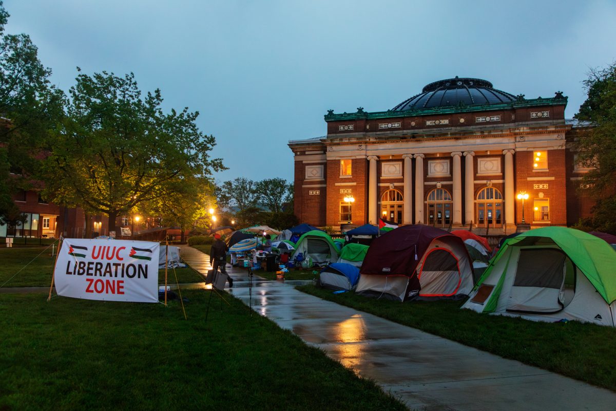 Encampment continues on the Main Quad in front of Foellinger Auditorium despite rain on Saturday evening.