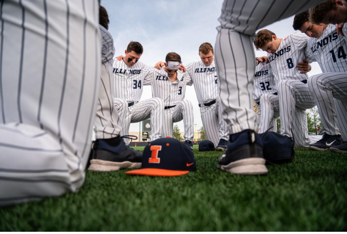 Illinois baseball players kneel before a game on May 3. The Illini are hoping for an NCAA D1 regional berth. 