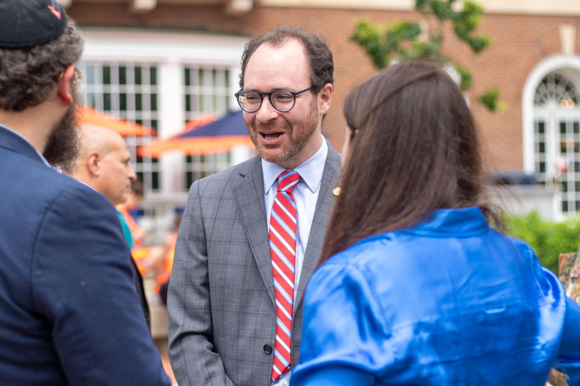 State Representative Daniel Didech speaks to Rabbi Dovid Tiechtel in front of the Union on Monday.