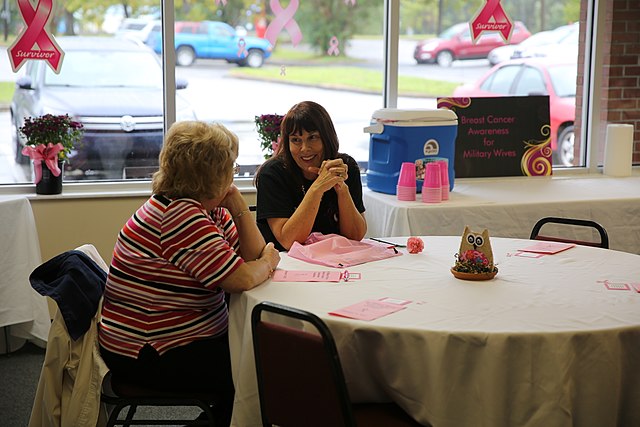 Two+cancer+survivors+share+their+stories+at+a+breast+cancer+awareness+luncheon.