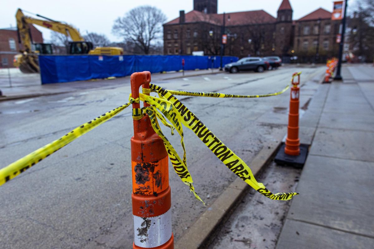 Caution tape lines the sidewalk next to East John Street as work begins on Illini Hall at 725 S. Wright St. in Champaign.