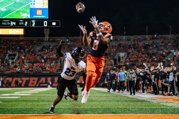 Sophomore wide receiver Malik Elzy reaches up to catch a pass in the endzone from junior quarterback Luke Altmyer to score a touchdown in home opener against Eastern Michigan.