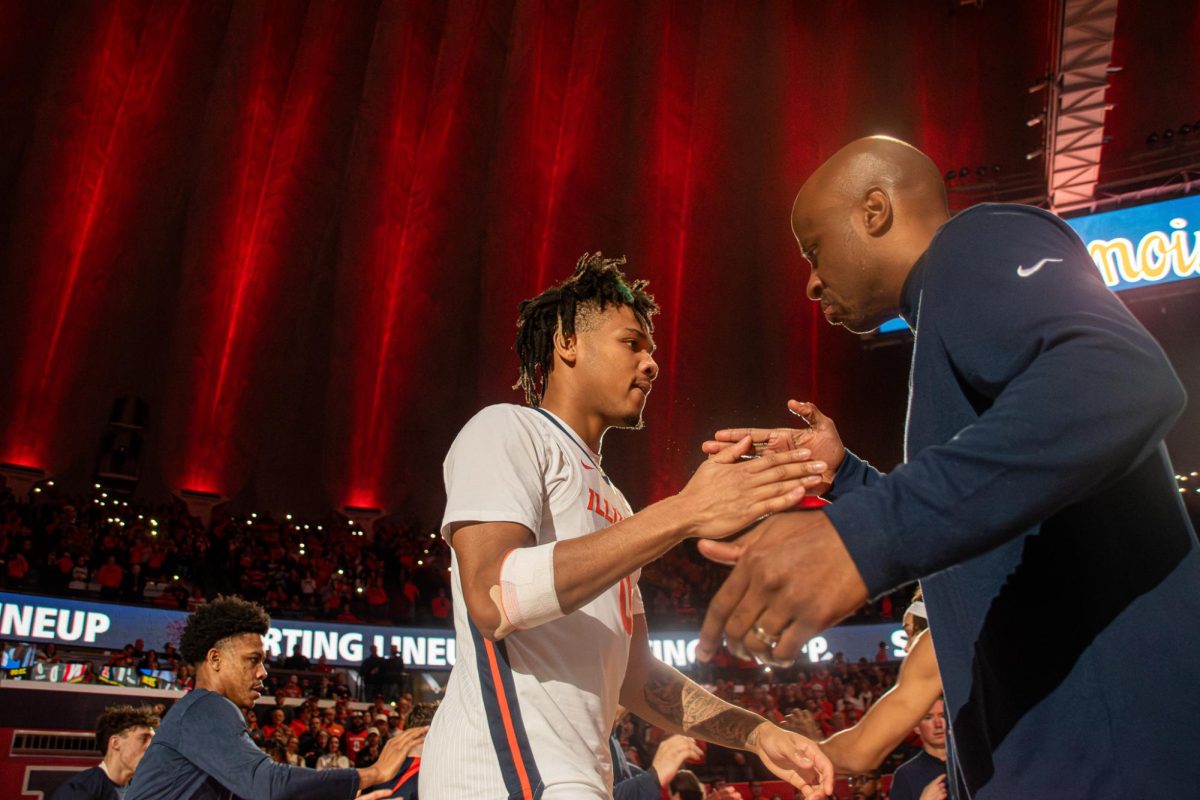 Terrence Shannon Jr high daps a coach before a game at the State Farm Center on Feb. 4.