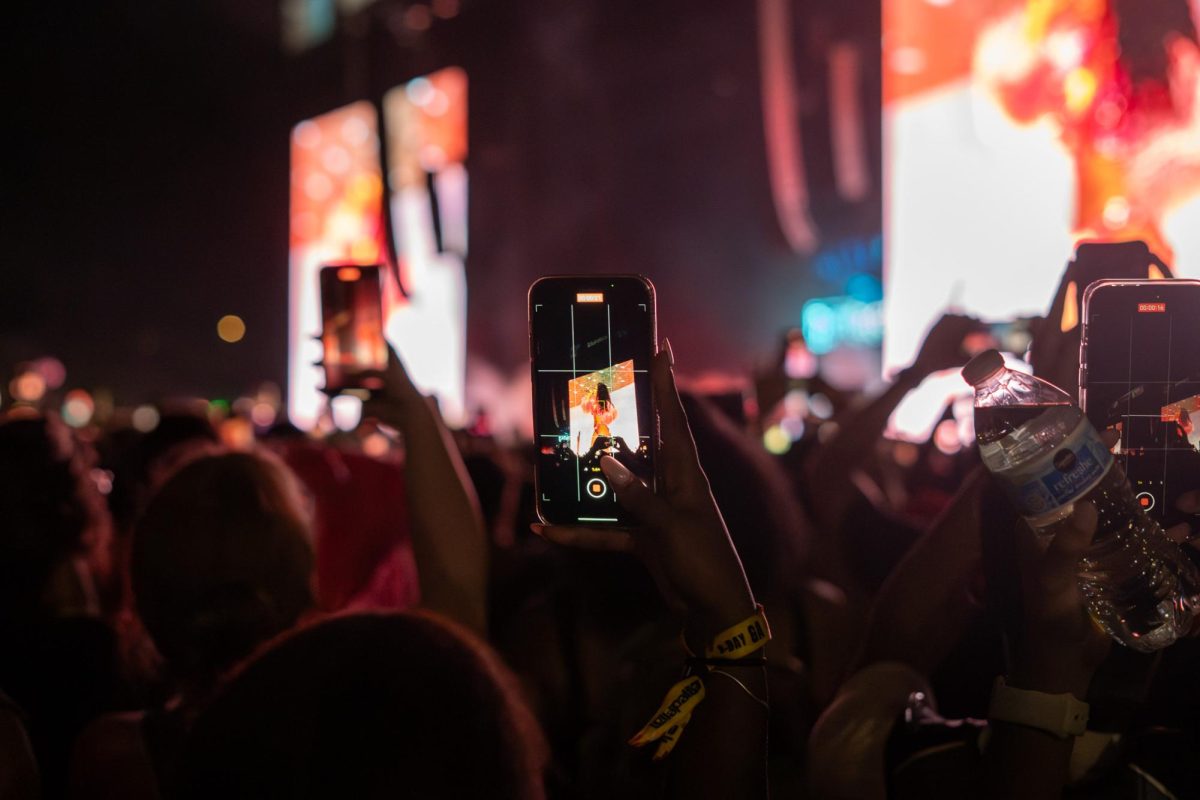 A fan records a video of Megan Thee Stallion during her headline performance at the T-Mobile stage on Thursday.