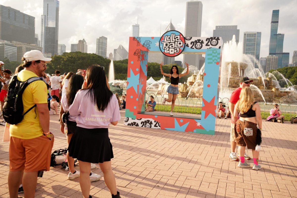 Lollapalooza festival goers line up for a photo in front of the Clarence F. Buckingham Memorial Fountain in Grant Park during day one of Lollapalooza on Aug. 1.