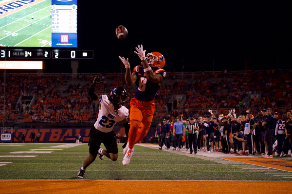 Sophomore wide receiver Malik Elzy reaches up to catch a pass in the endzone from junior quarterback Luke Altmyer to score a touchdown in home opener against Eastern Michigan. 