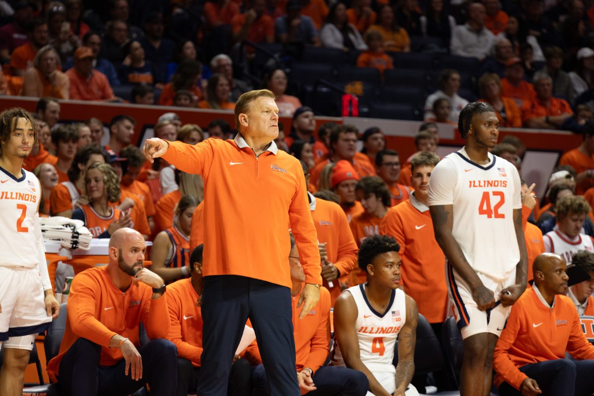 Head coach Brad Underwood watches as Illinois takes on Kansas in an exhibition game last season. Underwood’s Illini are set to take on four top 25 schools in the 2024-25 season.