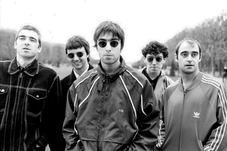 A group picture of Oasis, a popular band from the 90’s.